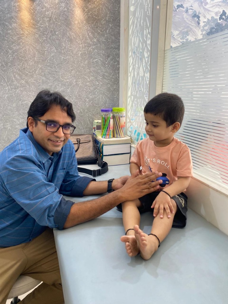 Dr. Ankur Khandelwal examining child at Sparsham Clinic Indore